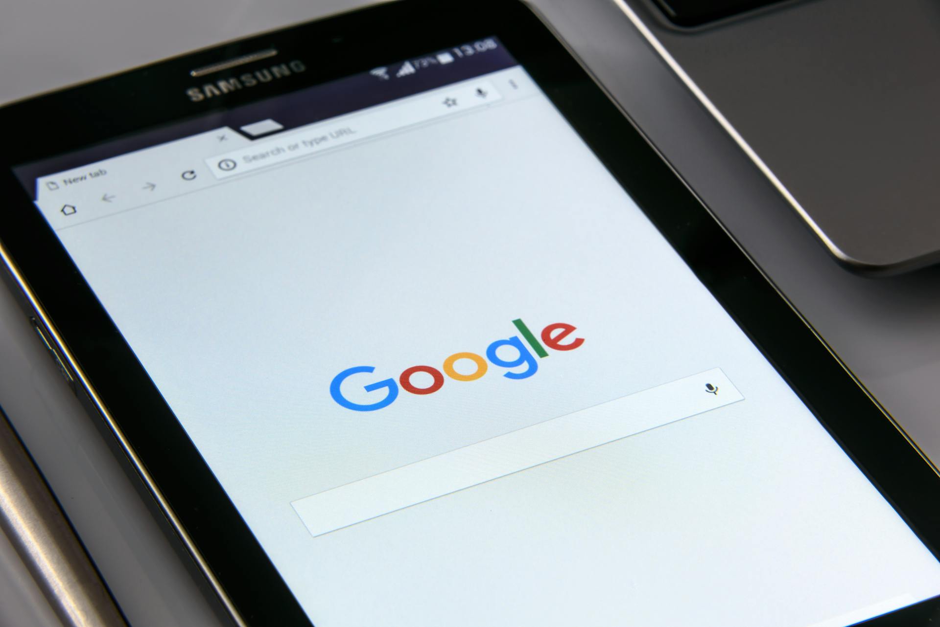 An image of a tablet showing the google search bar